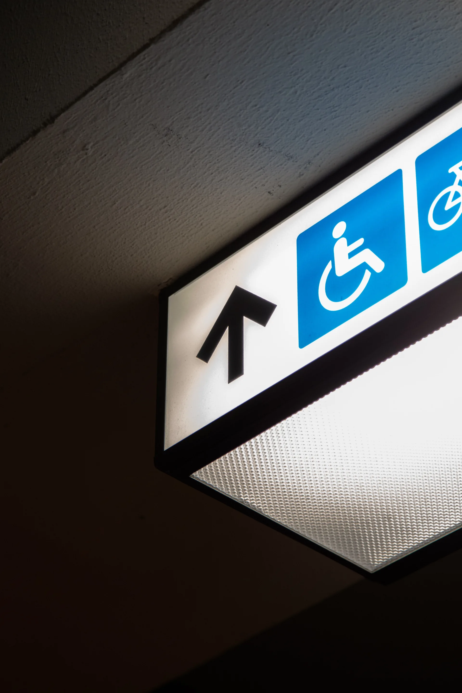 Sign in the ceiling with the symbol for wheelchair