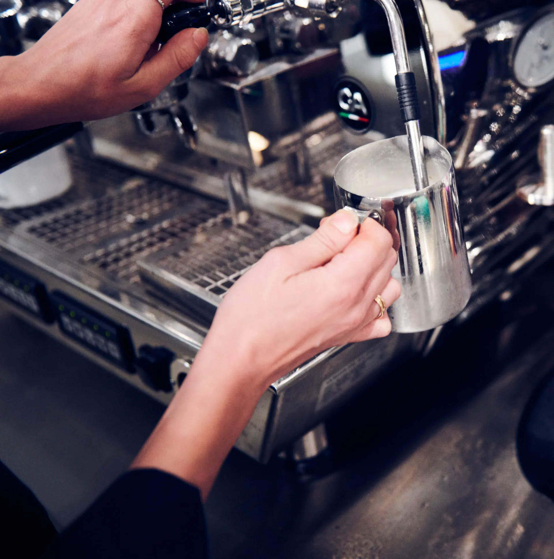 Person making coffee in an espresso machine