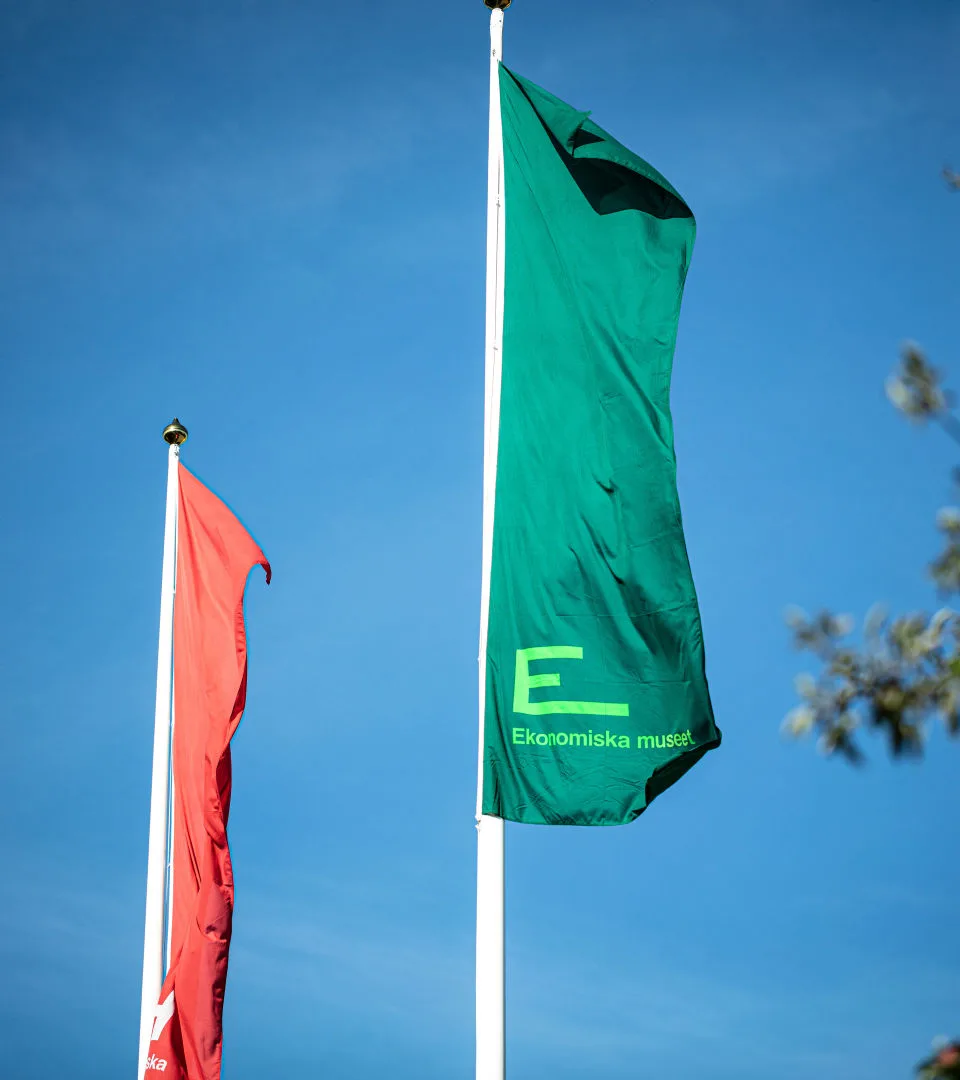 Flags with the Economy Museum's logo