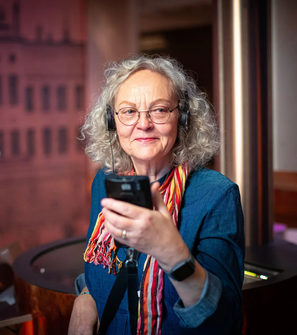 A person listening to an audio guide in the museum's exhibition.