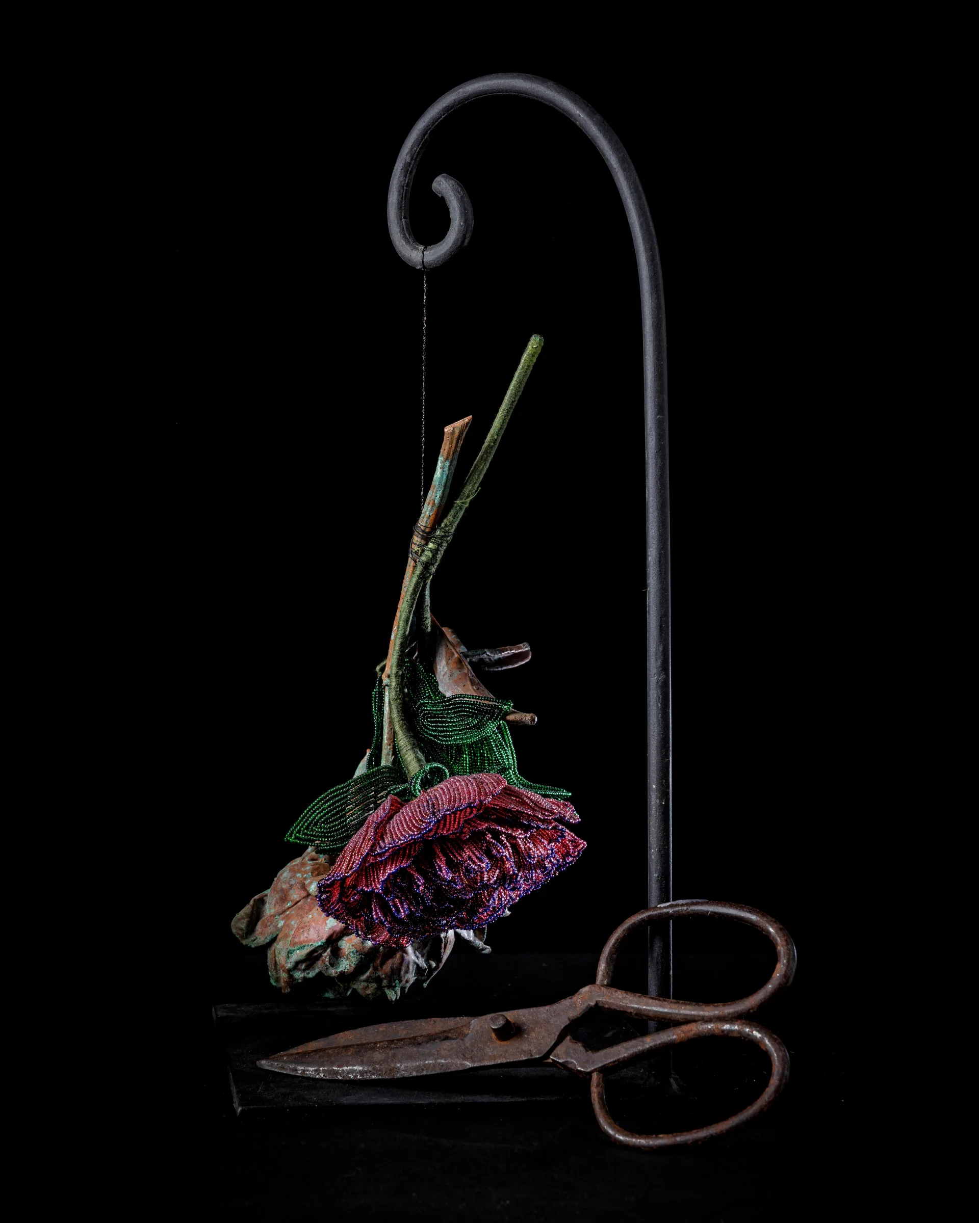 Flower decorated with beads hanging on a string