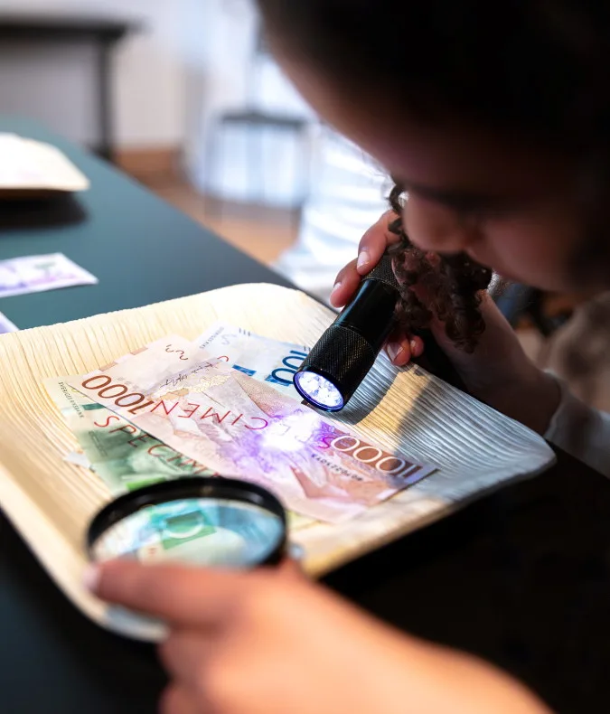 magnifying glass anf flashlight on bank notes